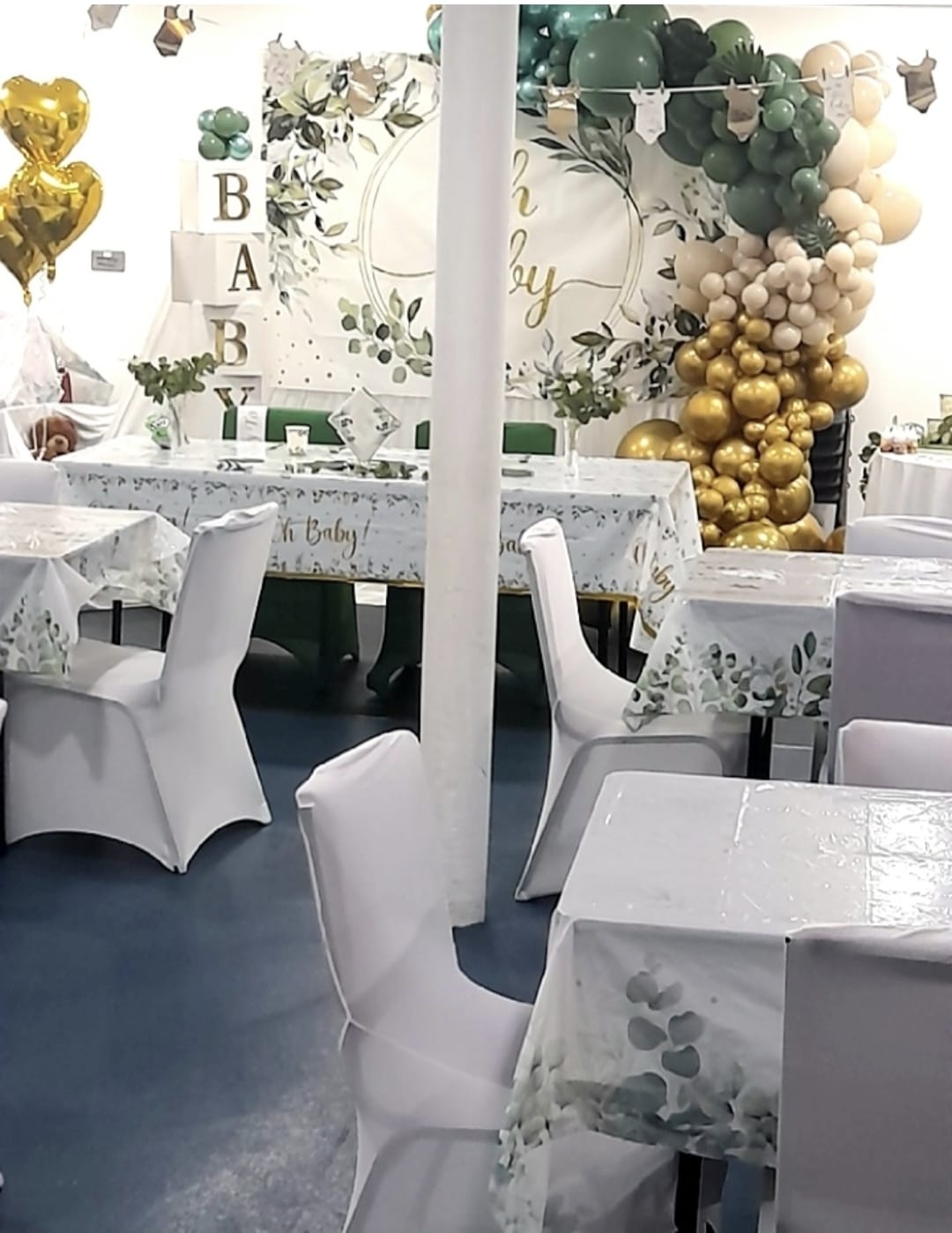 Green and gold baby celebration setup