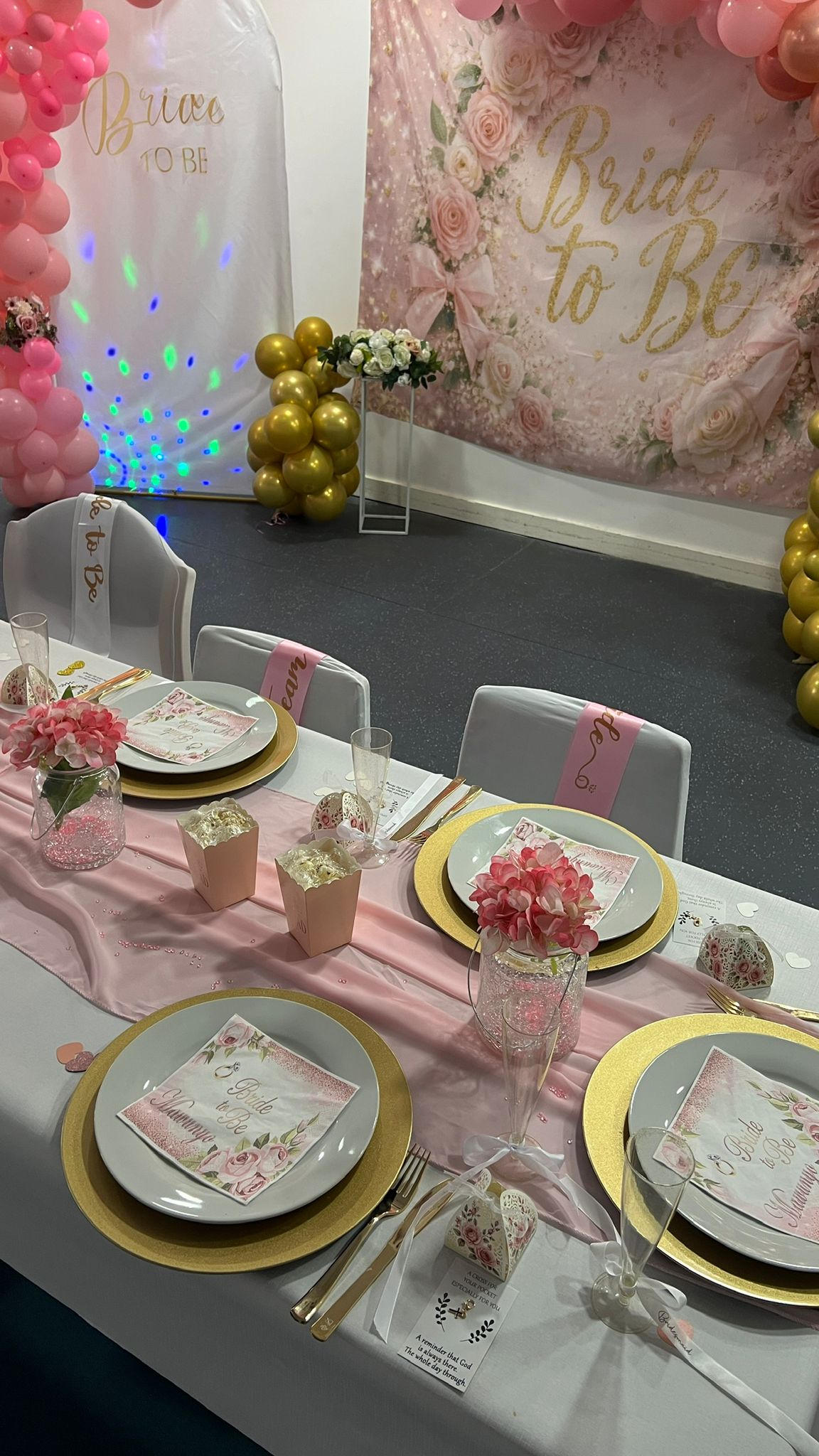 Bride-to-be table setting beside the balloon backdrop