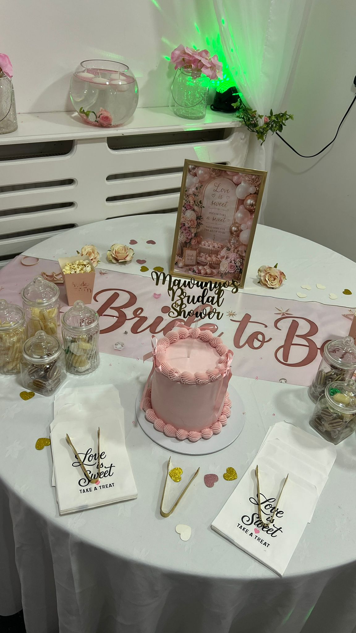 Bridal shower cake table with sweet jars and keepsake sign